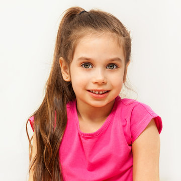 Portrait of smiling brunette seven years old girl