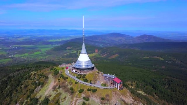 Aerial view of Jested tower on the top of Jested mountain. Jested tower is National cultural monument of Czech republic. Famous tourist public attraction near Liberec. Drone camera flying over Jested.