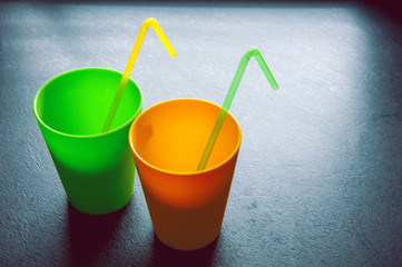 two cups with the tube on the black background
