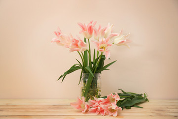 Glass vase with beautiful tulips on light background