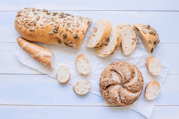 Fresh bread on the blue wooden background top view
