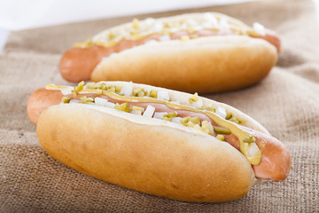 Hot dog grill with mustard, onion and pickles