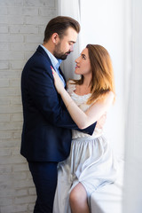 love concept - young beautiful couple kissing at home