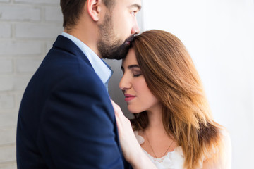 love concept - close up portrait of young beautiful couple at home