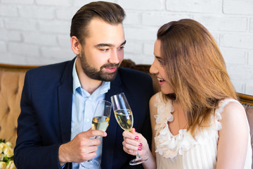 young beautiful couple with glasses of champagne  celebrating something