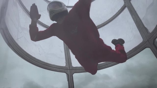 Girl flying trains with a parachute jump. Extreme parachuting. Simulator flying with a parachute