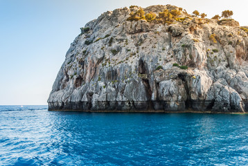Blue sea and sharp rocks that surround it