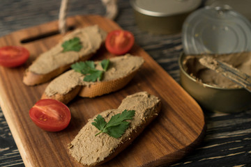 Fototapeta na wymiar Liver pate on the bread on wooden tray.