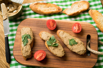 Obraz na płótnie Canvas Liver pate on the bread on wooden tray.