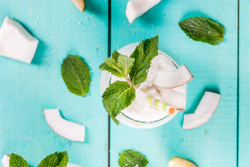 Summer refreshment drinks, cocktails. Frozen coconut mojito with lime and mint. Pina colada. On a...
