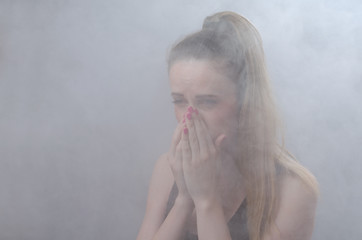 The girl suffocates from thick smoke