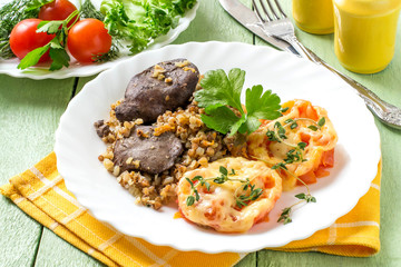 Buckwheat with stewed chicken liver and tomatoes baked with cheese
