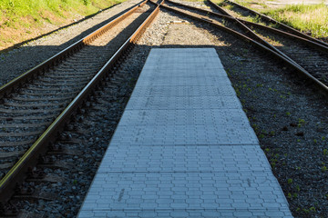 railroad track winding through green summer forest