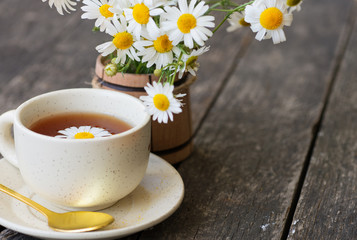 cup of herbal chamomile tea with camomile dry blossoms, dried camomile flowers. doctor treatment and prevention of immune concept, medicine - folk, alternative, complementary, traditional medicine