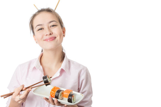 young woman with sushi smiling on white background