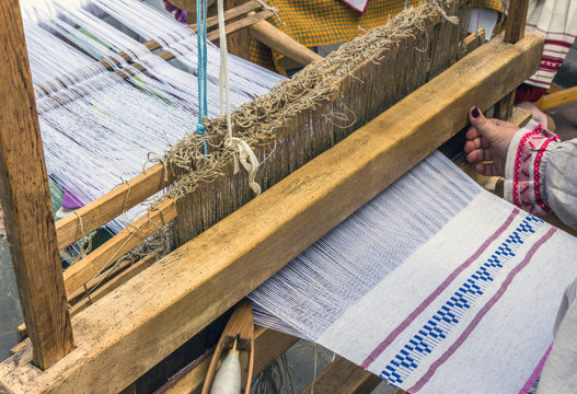 slavic linen on loom, woman hand weaving