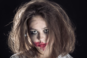 pretty fun crazy girl with fluffy hair and smeared cosmetics on black background