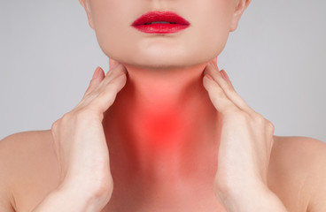 Young woman has sore throat touching the neck