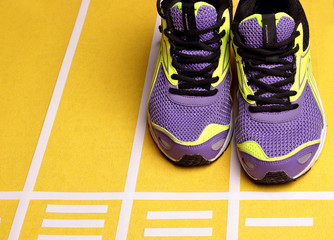 Runing shoes.On runing trrek.Copy space .Sneakers.Yellow background