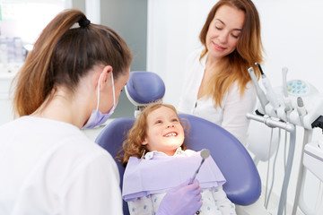 Dentists examining little girl