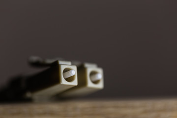 Fiber optics cable. Fiber to the home internet. LC connector, macro shot, isolated blurry backgroud