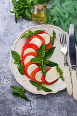 Italian caprese salad with mozzarella, tomatoes and basil