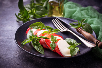 Italian caprese salad with mozzarella, tomatoes and basil