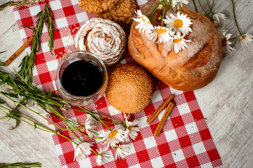 Coffee Cup, cracker, cookie, biscuit, chamomile flowers on a wooden table.