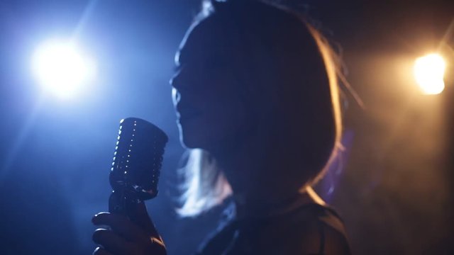 Silhouette of woman with retro style microphone
