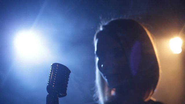 Silhouette of woman with retro style microphone