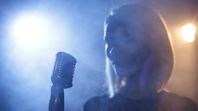Silhouette of woman with retro style microphone