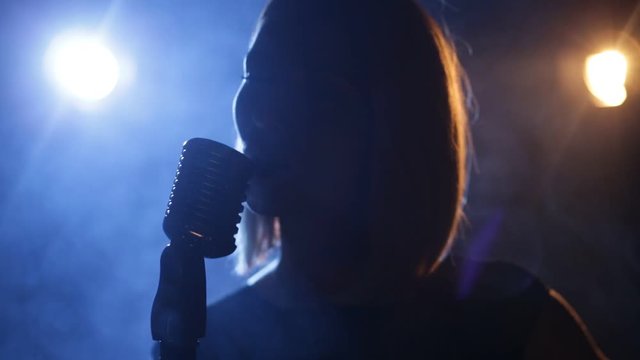 Silhouette of woman with retro style microphone