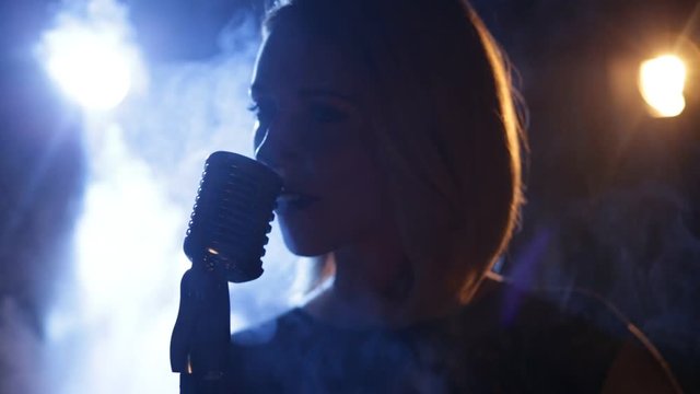 Silhouette of woman with retro style microphone