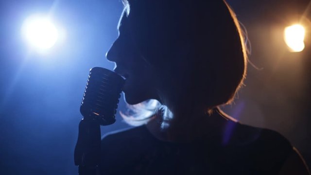 Silhouette of woman with retro style microphone