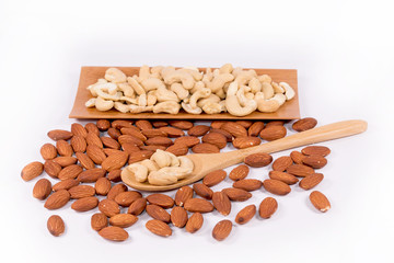 Delicious cashew nuts   in wooden spoon and almond nuts