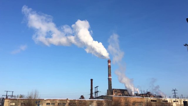 Factory fuming pipe on the background of clear blue sky