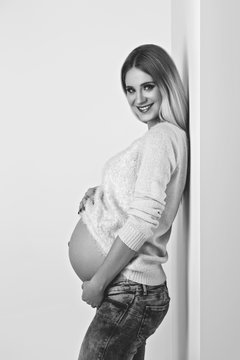 Beautiful pregnant woman in jeans