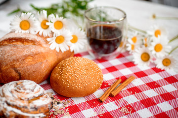 Coffee Cup, cracker, cookie, biscuit, chamomile flowers on a wooden table.