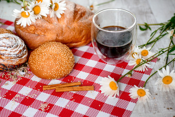 Coffee Cup, cracker, cookie, biscuit, chamomile flowers on a wooden table.