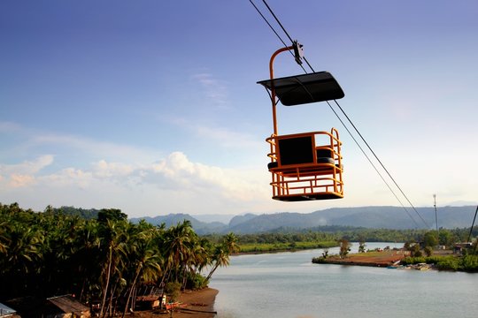 A cable car glides down thick cables above the river in Carrascal, Surigao del Sur, Philippines.
