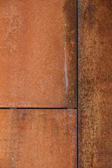 A rusty metal wall with seams and joints