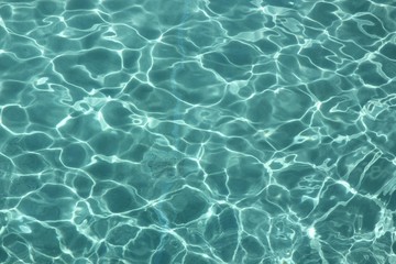 Clear water with reflections from the sun A backdrop of clear water in a swimming pool reflected by...