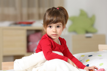 Portrait of a beautiful toddler girl in her room
