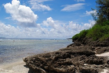 Fototapeta na wymiar Rocky beach shores, Coral Ocean Point, Saipan Coastal view of beautiful rock formations at the Coral Ocean Point in Saipan, Northern Mariana Islands