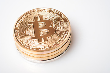 Stack golden bitcoin isolated on white background