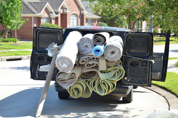 Van loaded with carpet and padding rolls for flooring installation