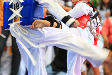 Taekwondo athletes fighting on stage - obrazy, fototapety, plakaty