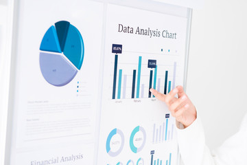 Businesswoman hand pointing at the graph on the board, presenting information