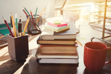 Stack of books and stationery on the desk