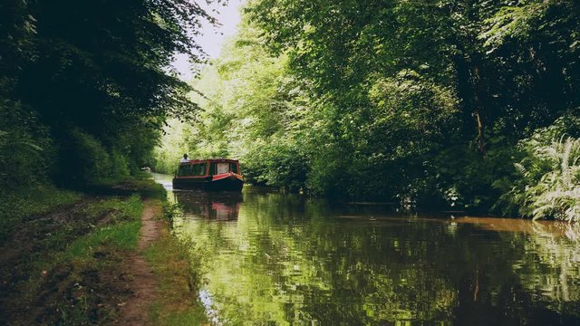 narrow boats cruising canal in summer - Shropshire Union Canal, Staffordshire, England - June 19th 2017